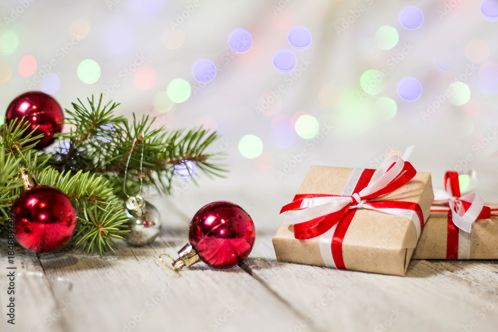 Gift boxes and colorful decorated Christmas tree on bokeh background with copy space