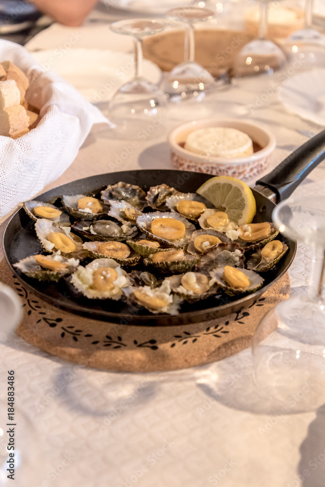 Fototapeta premium Azorean limpets served in a restaurant in Mosteiros on the island of Sao Miguel in the Azores, Portugal