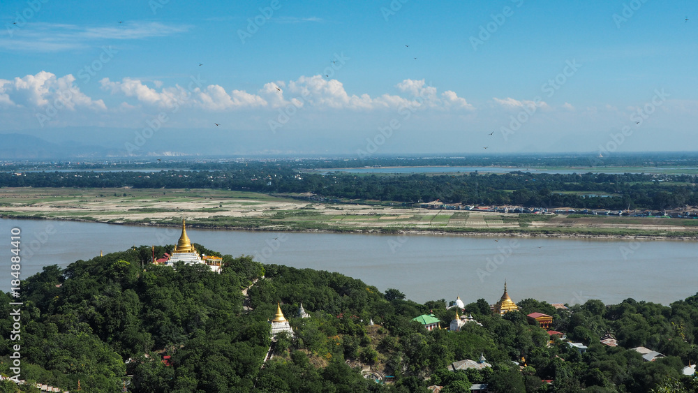 High angle view of multiple temples and pagodas on the mountains with Irrawaddy river in the background from sagaing hill, Sagaing region of Myanmar