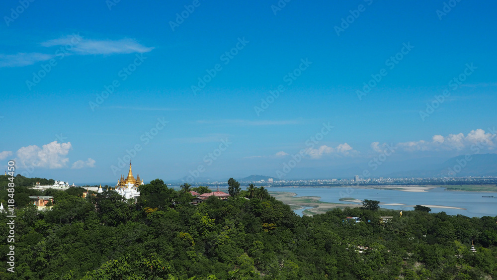 High angle view of multiple temples and pagodas on the mountains with Irrawaddy river in the background from sagaing hill, Sagaing region of Myanmar