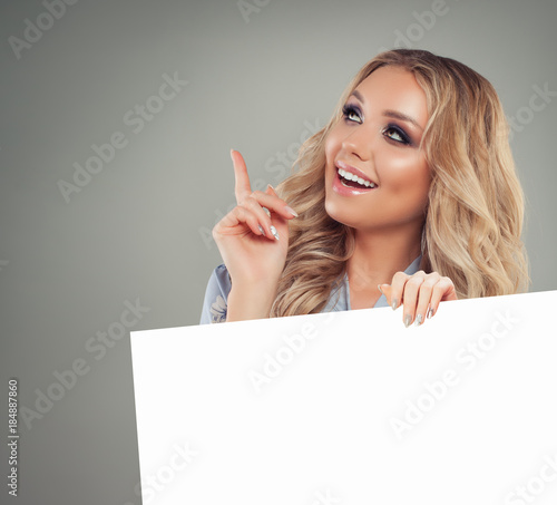 Smiling Woman Pointing her Finger and Holding White Paper Banner Background