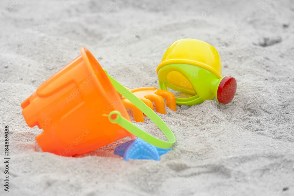 Set of color plastic toys on a sand Set of color plastic toys on a sand