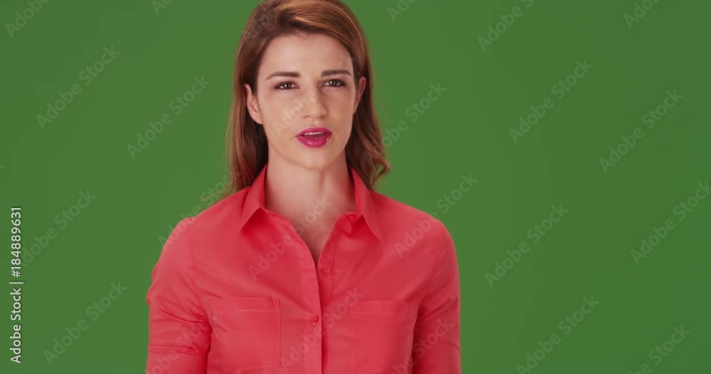 White businesswoman talking to the camera on green screen. On green screen to be keyed or composited. White businesswoman talking to the camera on green screen. On green screen to be keyed or composited.