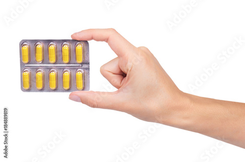 Capsules pills in hand isolated on white background