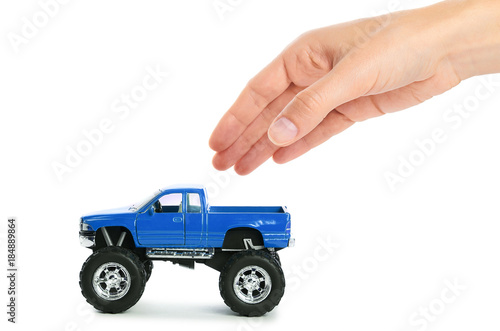 big metal red toy car offroad with monster wheels in hand isolated on white background