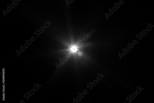 Fototapeta Naklejka Na Ścianę i Meble -  White light flare special effect in dark black.