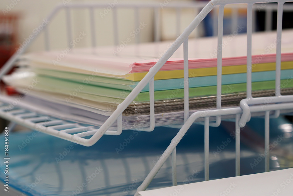  Stack of document tray with document multicolor paper on desk in office