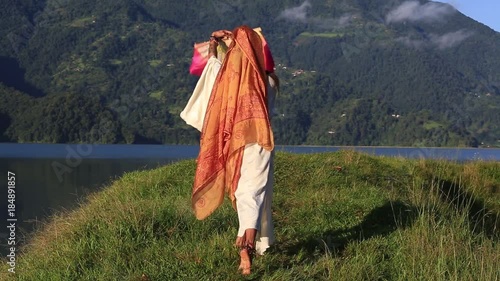 Sirena Sabiha dancing with a fan at sunrise in Pokhara, Nepal. Sirena was born in the Philippines. Close up photo