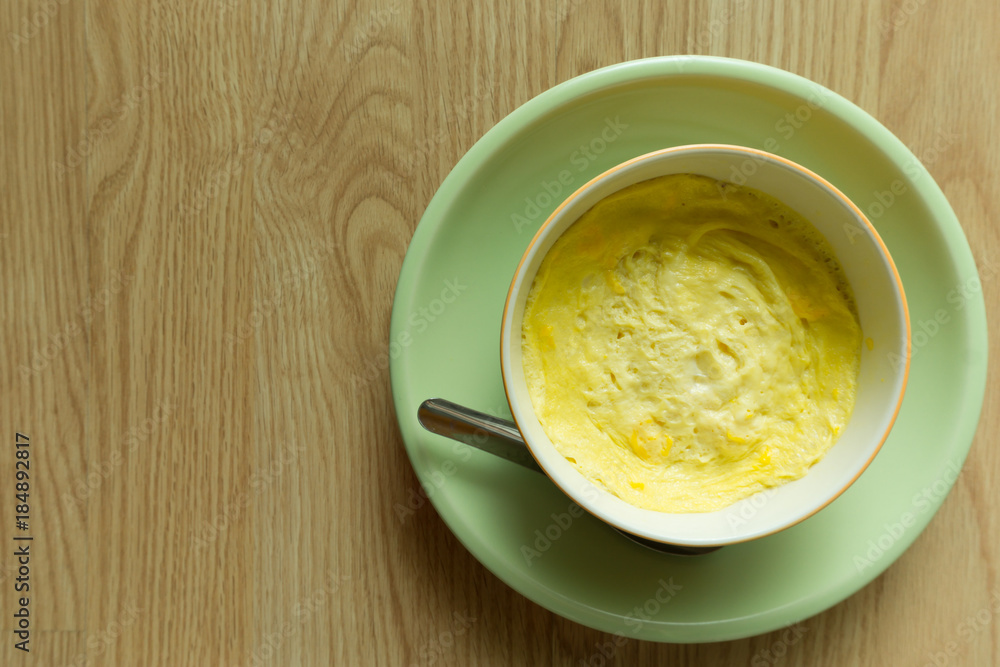 Steamed eggs in a bowl on wooden floor Steamed eggs in a bowl on wooden floor