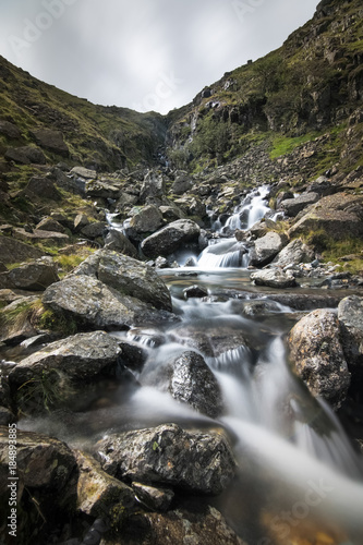 Waterfall valley with beautiful creek with pure white water in Cumbria Lake District England