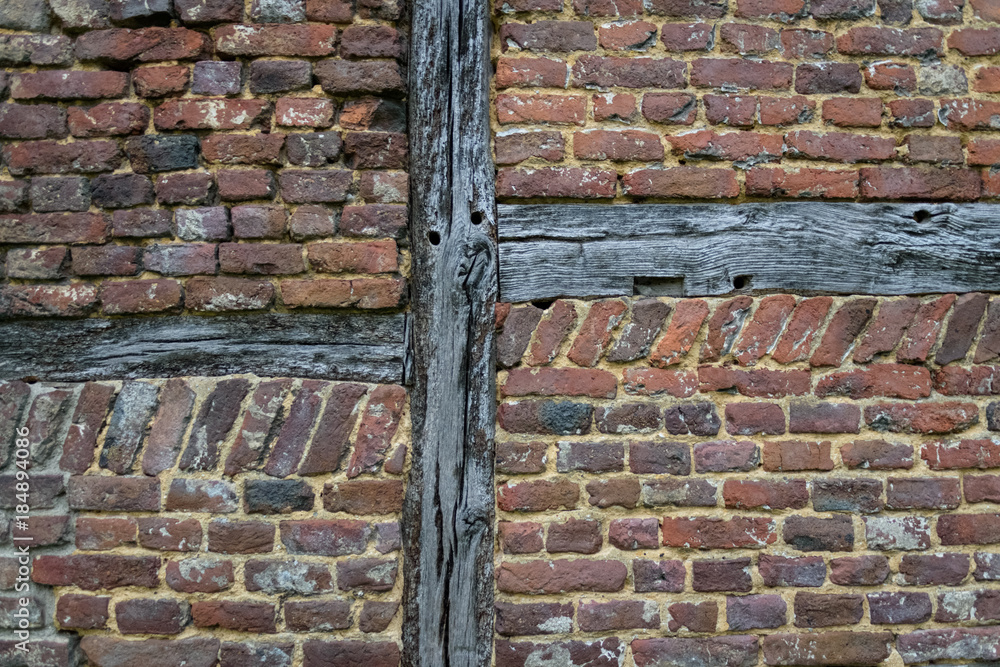 Old ancient wall with wood pattern and aged red bricks background Old ancient wall with wood pattern and aged red bricks background