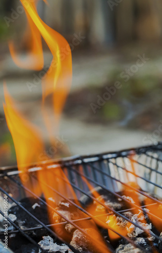 Burning flames over barbecue closeup