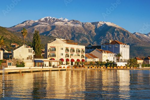 Sunny winter day in Montenegro. Embankment of Tivat city and snow-capped peaks of Lovcen mountain © Olga Iljinich