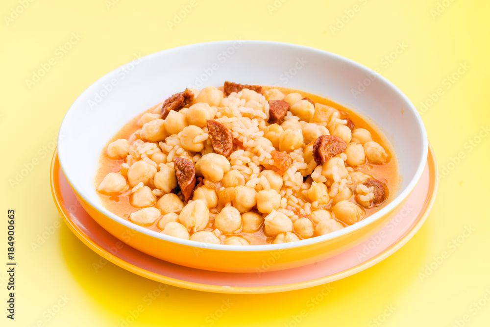 stewed chickpeas in modern dish on yellow table stewed chickpeas in modern dish on yellow table