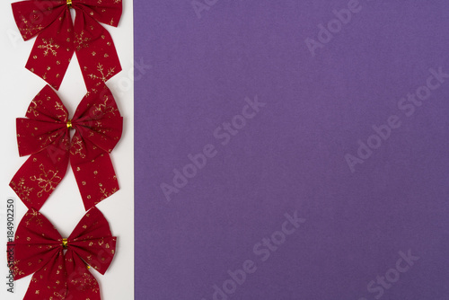 red Christmas bows on a colored background 