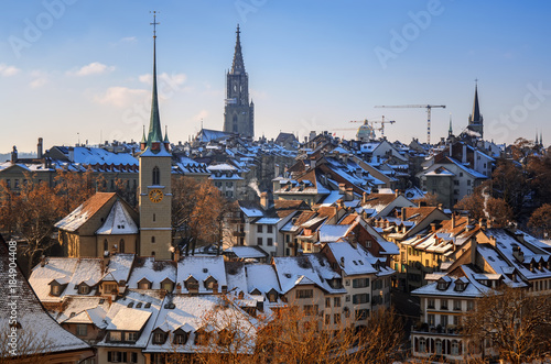 View of old part of city of Bern, Church of Nydeggkirche and Spire of Bernese Cathedral. Winter in Switzerland.