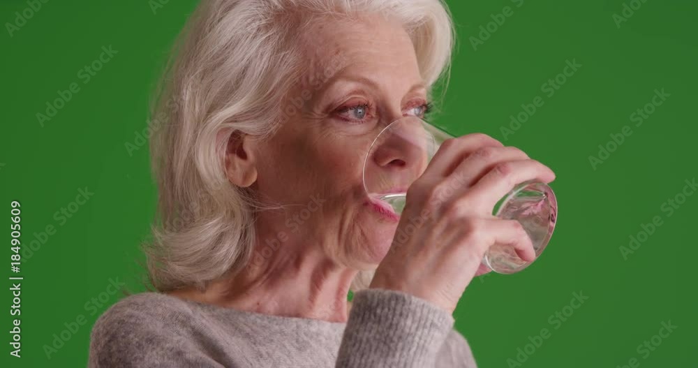 Close Up Of Attractive Elder Woman Swallowing Capsule Washing It Down close-up-of-attractive-elder-woman-swallowing-capsule-washing-it-down