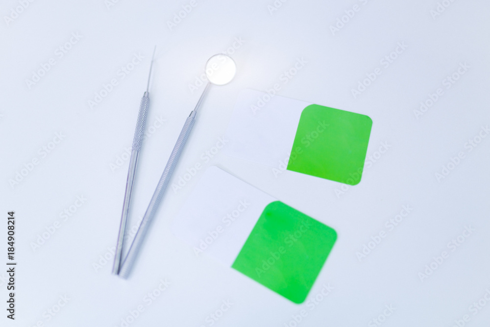 Photo of blank business cards on a white background.In addition, there is dental equipment.
Photo of blank business cards on a white background.In addition, there is dental equipment.
