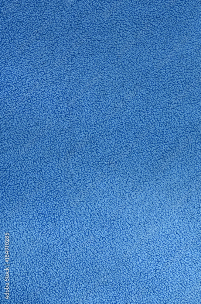 The blanket of furry blue fleece fabric. A background texture of light blue  soft plush fleece material Stock Photo