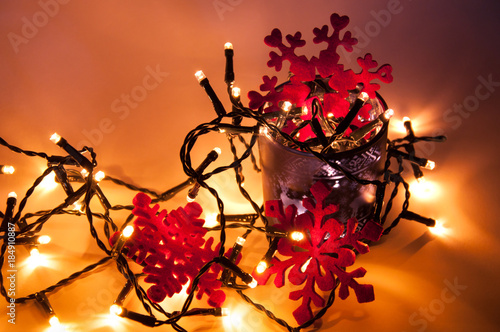Red snowflakes with christmas lights and blue festive cup © Vladyslav