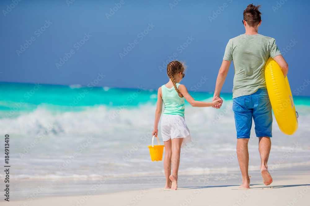 Family of father and little girl at tropical beach together