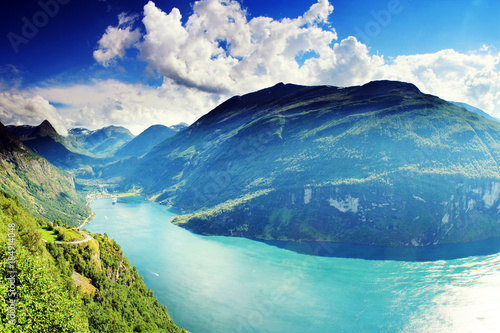 Beautiful colorful vibrant sunny Geiranger fjord Norway landscape with azure water