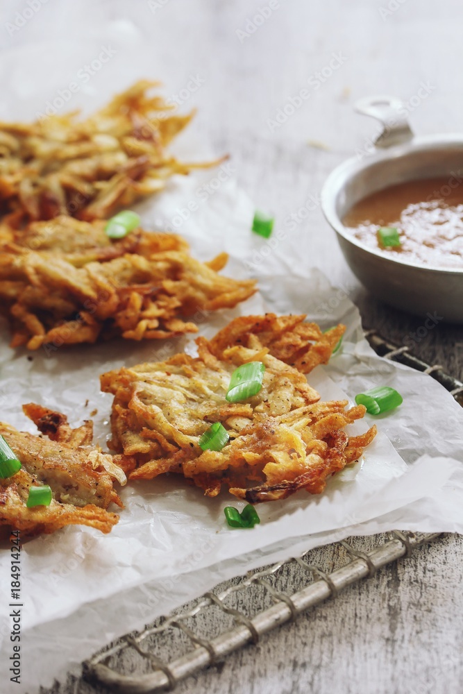 Potato Latkes - Hanukkah Pancakes served with apple sauce, selective focus Potato Latkes - Hanukkah Pancakes served with apple sauce, selective focus