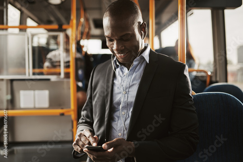 Young African businessman listening to music during his morning commute