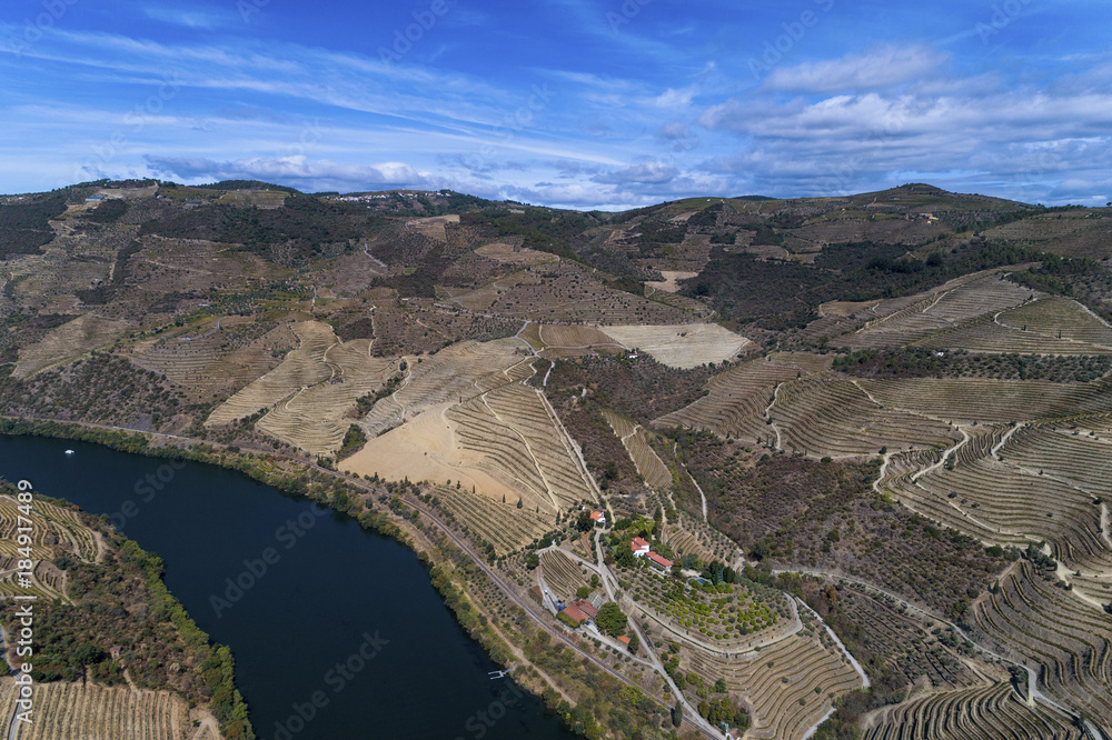 Aerial view of the Douro River and the surrounding terraced slopes and a wine making estate in Portugal, Europe; Concept for travel in Portugal and the Douro Region