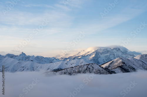 Winter panorama of the Italian Alps: Monte Rosa massif seen from the Biella pre-Alps. At sunset the fog rises from the valley bottom. © Arcansél