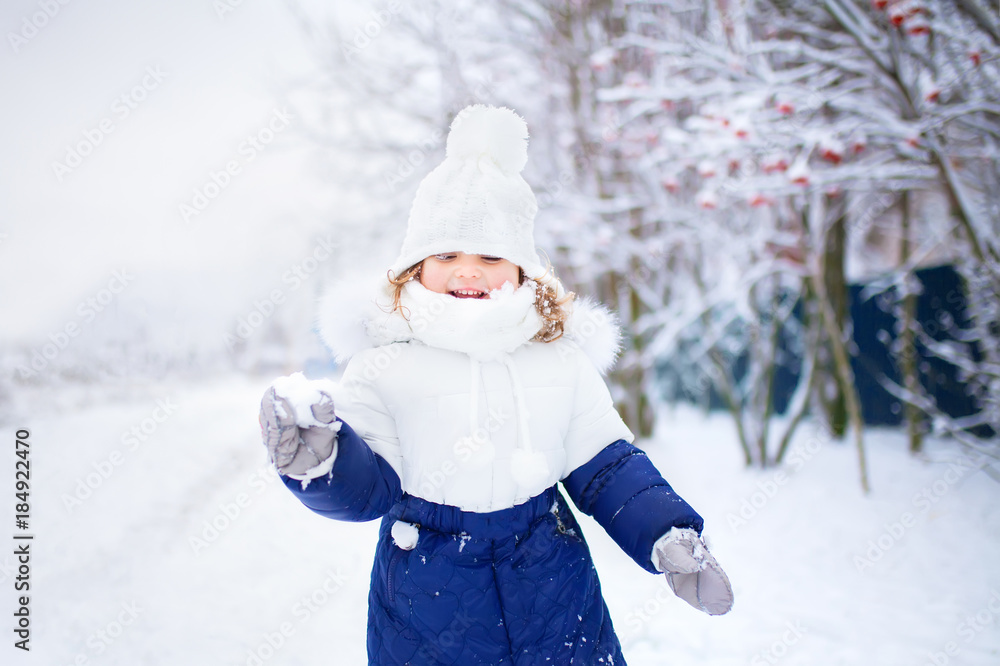Little girl playing snowballs, winter activity. Little girl playing snowballs, winter activity.