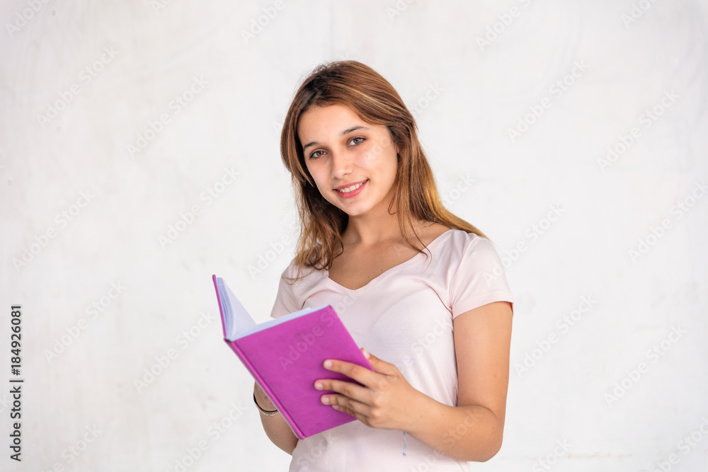 Caucasian teenager reading notebook, isolated on white Caucasian teenager reading notebook, isolated on white