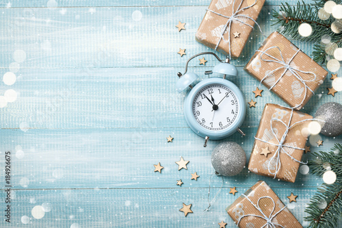 Christmas gift boxes decoration and alarm clock on wooden background