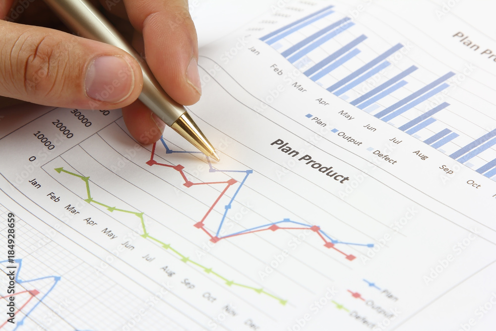 Hand man holding pen pointing on summary report chart Hand man holding pen pointing on summary report chart