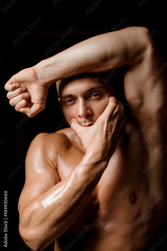 Strong athletic man posing in the studio