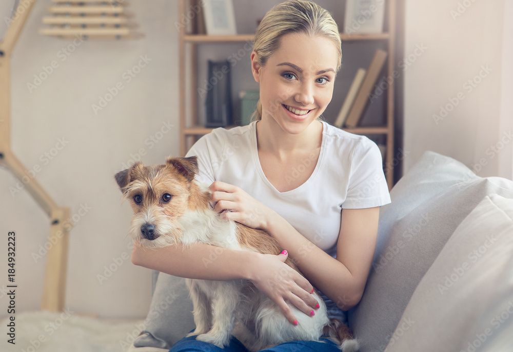 Young person with dog at home leisure