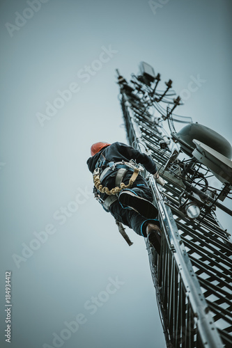 Telecom Worker Climbing Antenna Tower