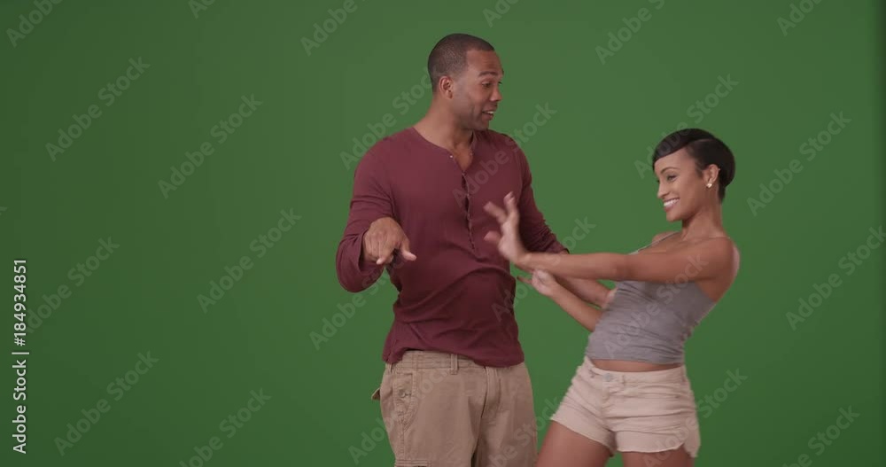 A black man and woman flirt on green screen. On green screen to be keyed or composited. A black man and woman flirt on green screen. On green screen to be keyed or composited.