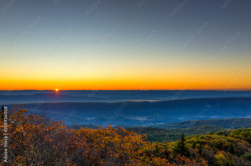 Obraz premium Morning dark sunrise with sky and golden yellow orange autumn foliage in Dolly Sods, Bear Rocks, West Virginia with overlook of mountain valley