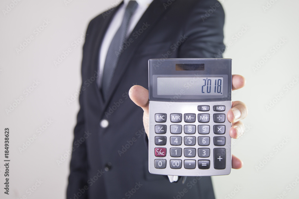 Business man showing a calculator Business man showing a calculator