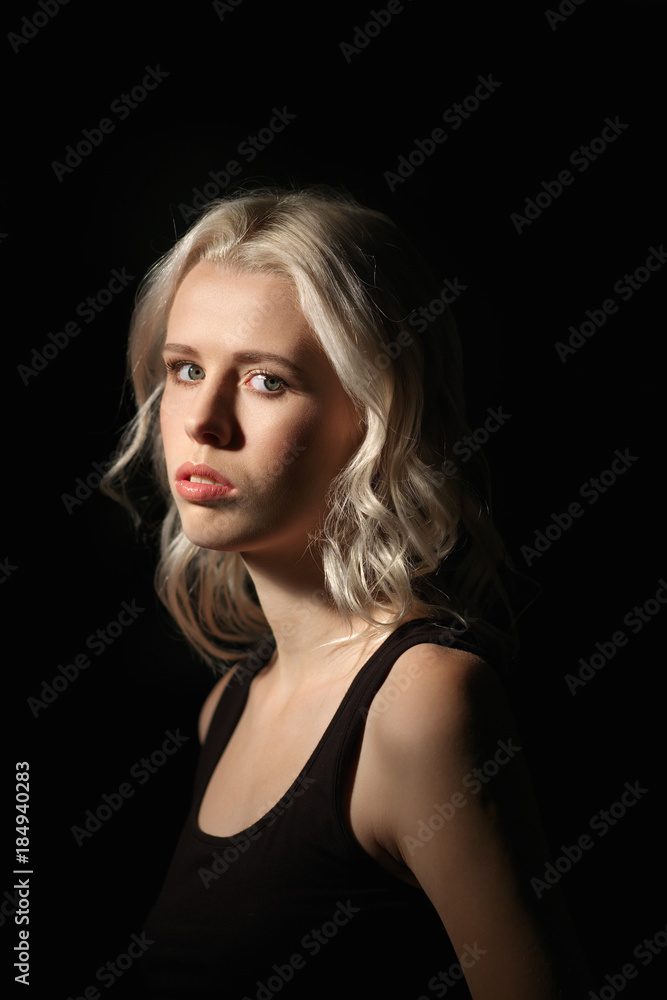 Calm girl with white hair and natural makeup on dark background