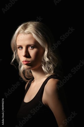 Calm girl with white hair and natural makeup on dark background