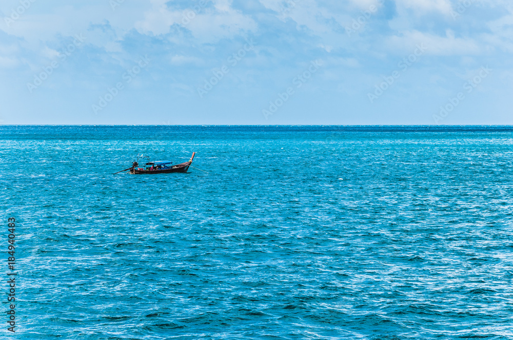 Small tailboat in the ocean