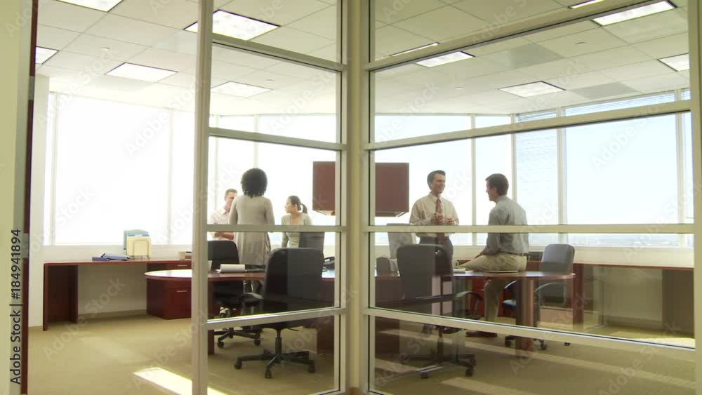 Young business collegues discussing work in two separate offices Young business collegues discussing work in two separate offices