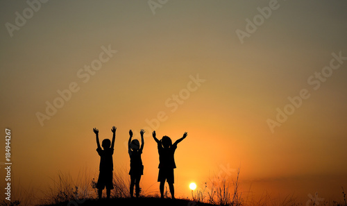 Silhouette of three children friendship at sunset.People friendship silhouette.