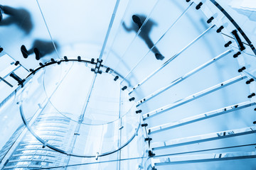Fotobehang Trappen Silhouetten op glazen wenteltrap  © onlyyouqj