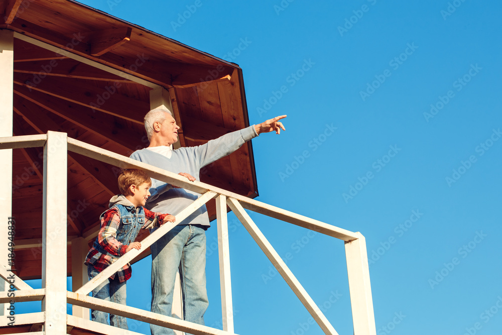Grandfather and grandson together outdoors family concept