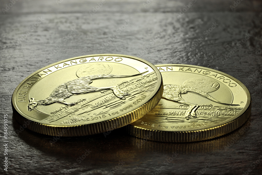 1 ounce Australian Kangaroo gold bullion coins on wooden background 1 ounce Australian Kangaroo gold bullion coins on wooden background