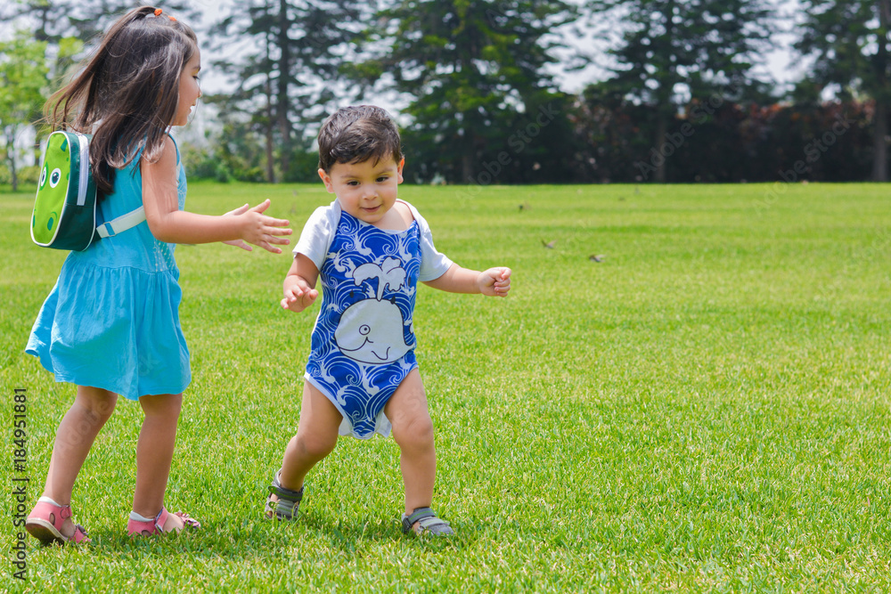 Little latin siblings playing in the summer park. Little latin siblings playing in the summer park.