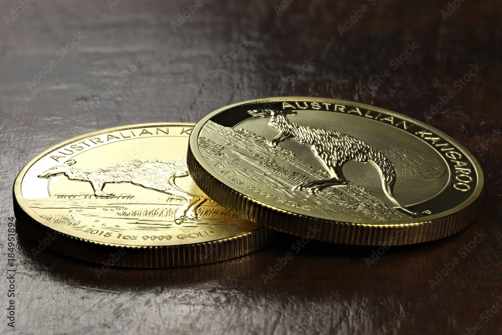 1 ounce Australian Kangaroo gold bullion coins on wooden background 1 ounce Australian Kangaroo gold bullion coins on wooden background